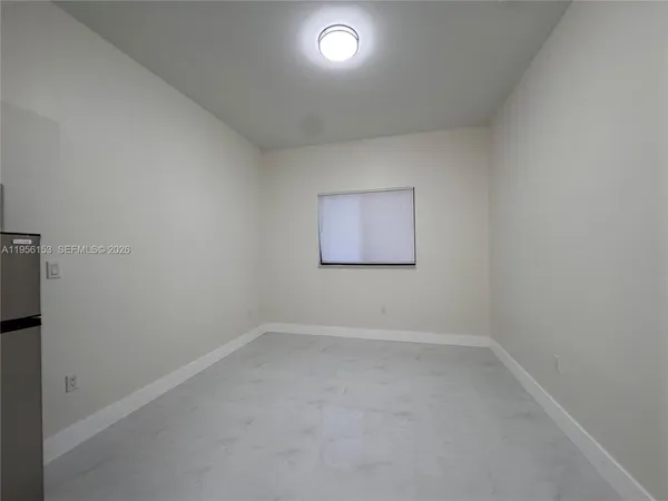 an empty room with a empty space and windows