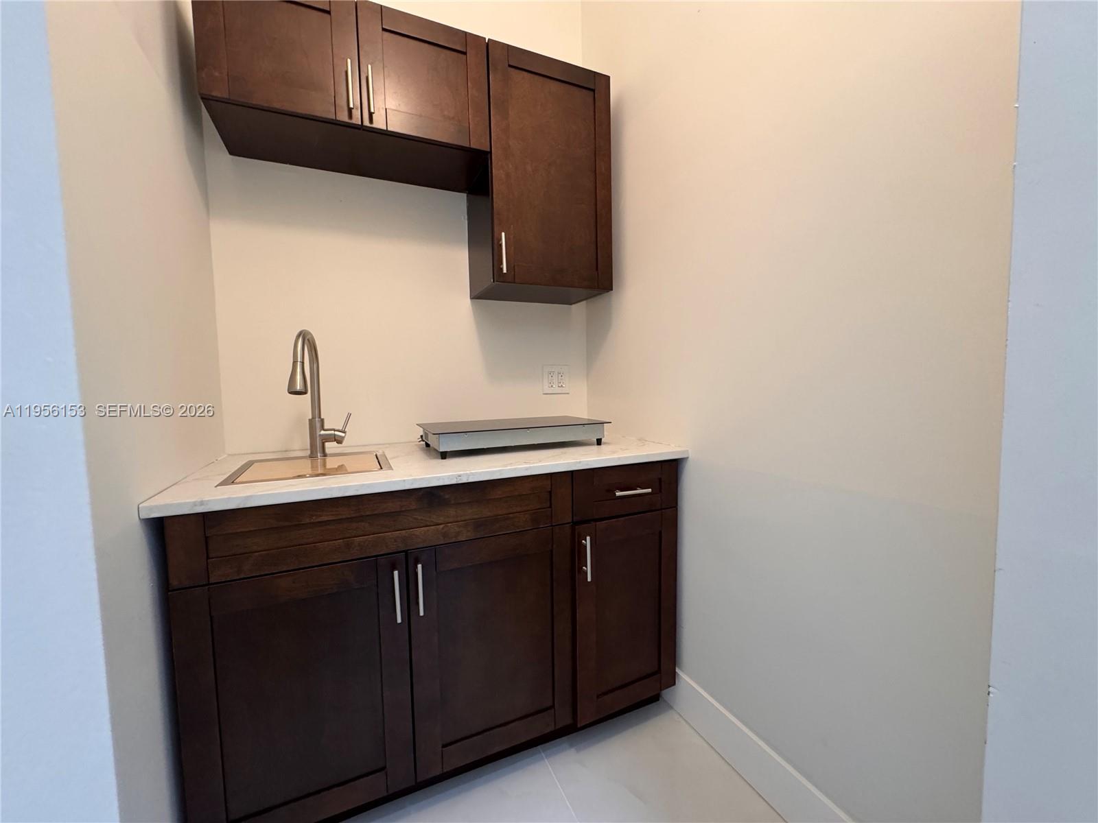 915 Northwest 104th Street, Unit BBACK Miami, FL 33150 - Photo 4 of 7 a bathroom with a sink and a mirror