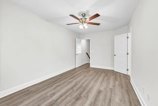 a view of an empty room and wooden floor