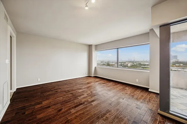 a view of an empty room and wooden floor