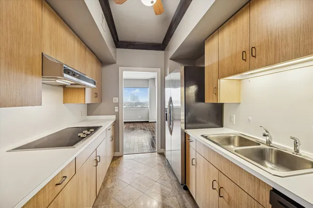 a kitchen with a sink and a refrigerator