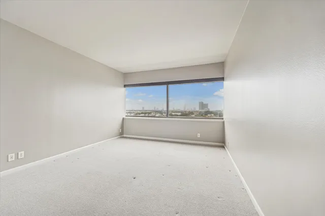 a view of a room with a sink and cabinets