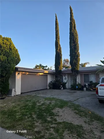 a view of a house with a yard and sitting area