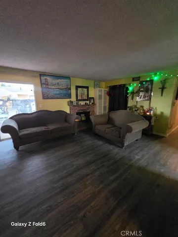 a living room with furniture a potted plant and a fireplace