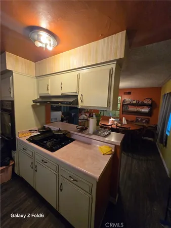 a kitchen with a stove and a refrigerator