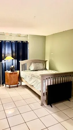 a bedroom with a bed and a night stand