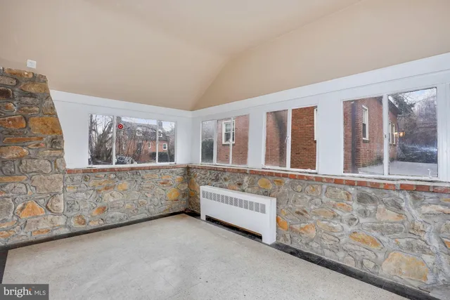 a view of an empty room with large windows