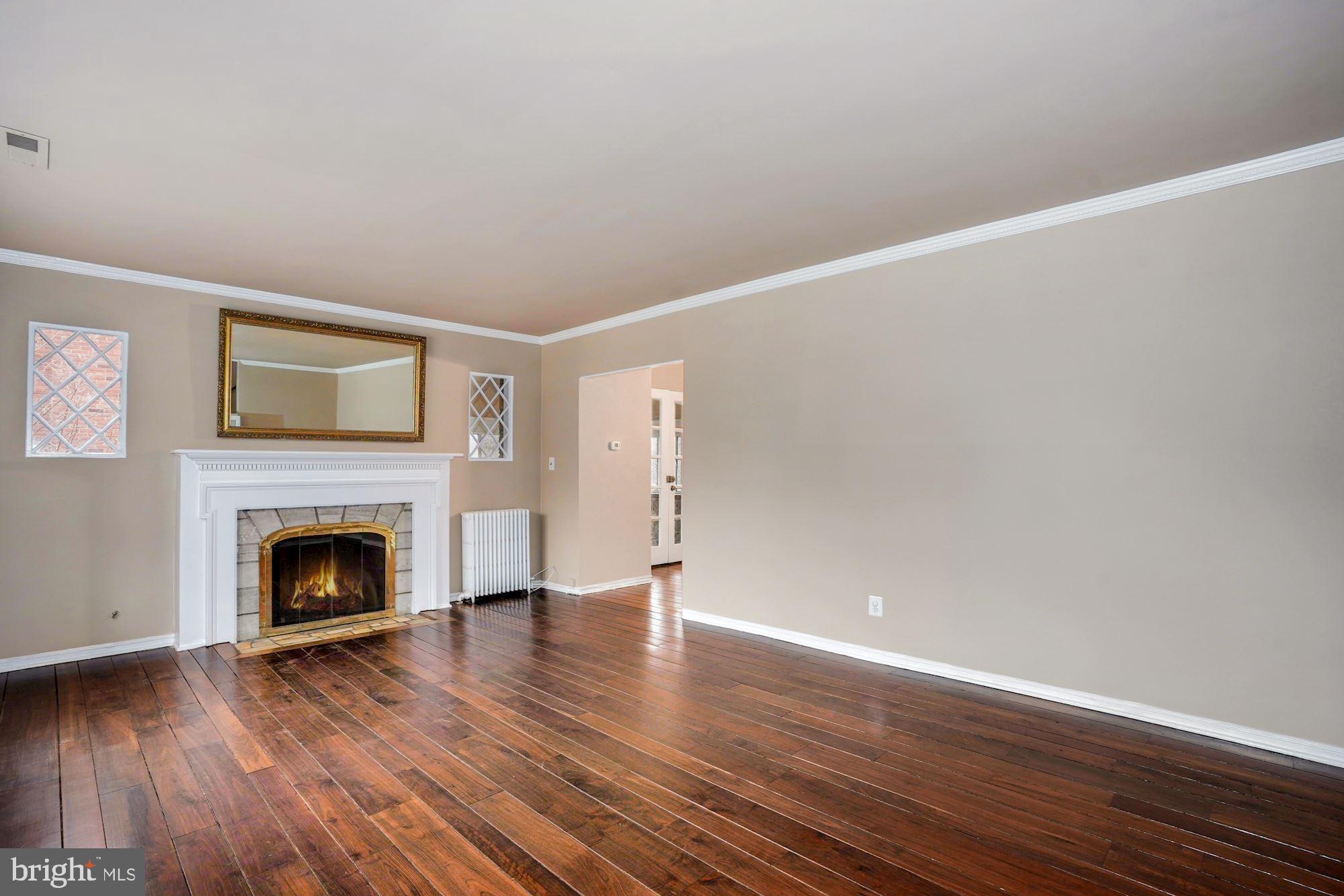 3209 19th Road North Arlington, VA 22201 - Photo 5 of 35 a view of an empty room with wooden floor fireplace and a window