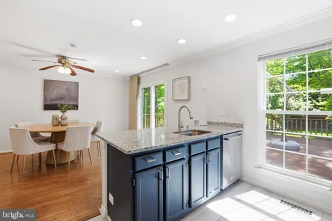 a kitchen with granite countertop a stove and a refrigerator