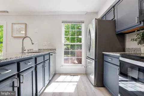 a kitchen with a refrigerator stove and microwave