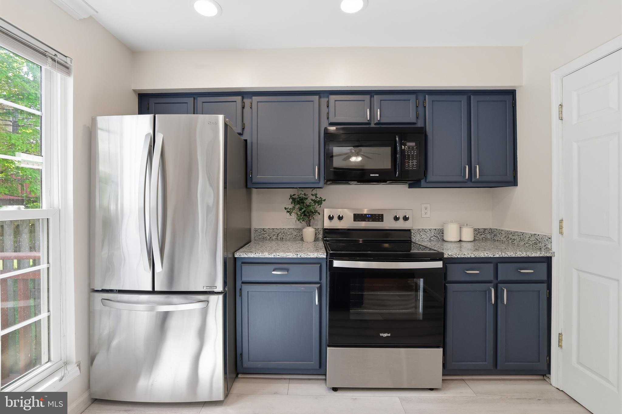 15029 Shamrock Ridge Road Silver Spring, MD 20906 - Photo 13 of 44 a kitchen with a refrigerator stove and microwave