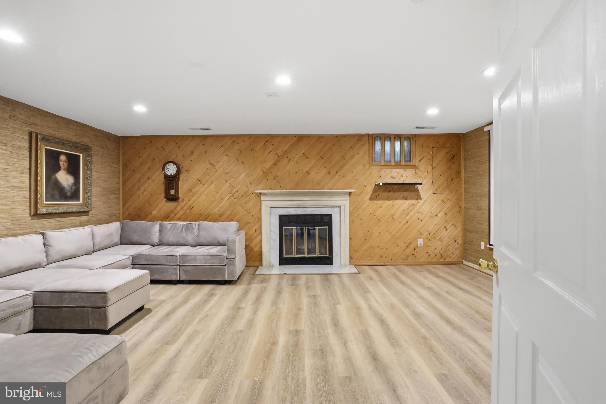 15029 Shamrock Ridge Road Silver Spring, MD 20906 - Photo 32 of 44 a living room with furniture and a fireplace