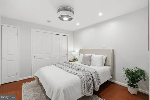 a bedroom with a bed and a painting on the wall