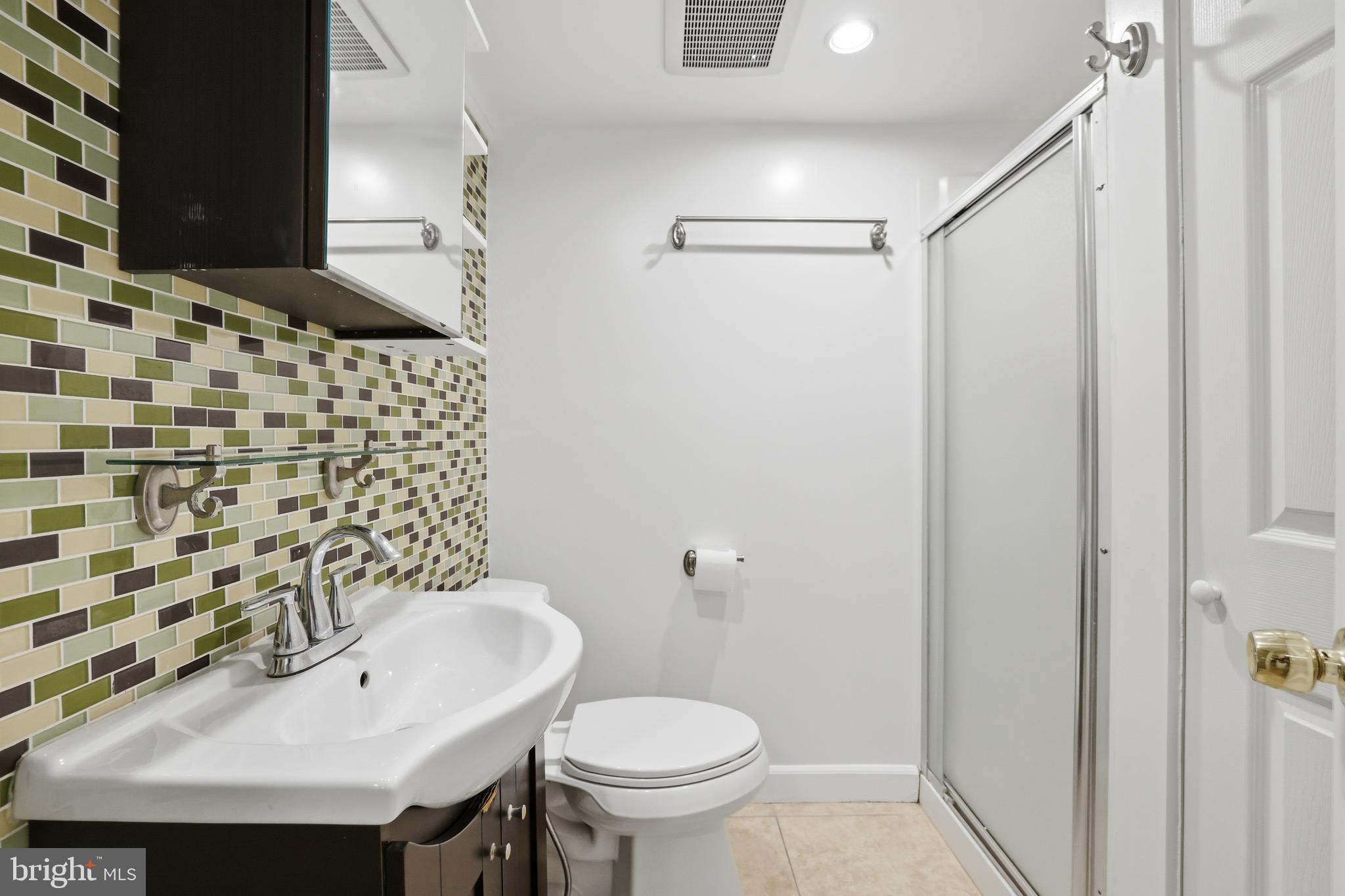 15029 Shamrock Ridge Road Silver Spring, MD 20906 - Photo 38 of 44 a bathroom with a sink and mirror with toilet