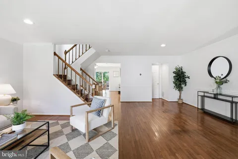 a view of entryway and hall with wooden floor
