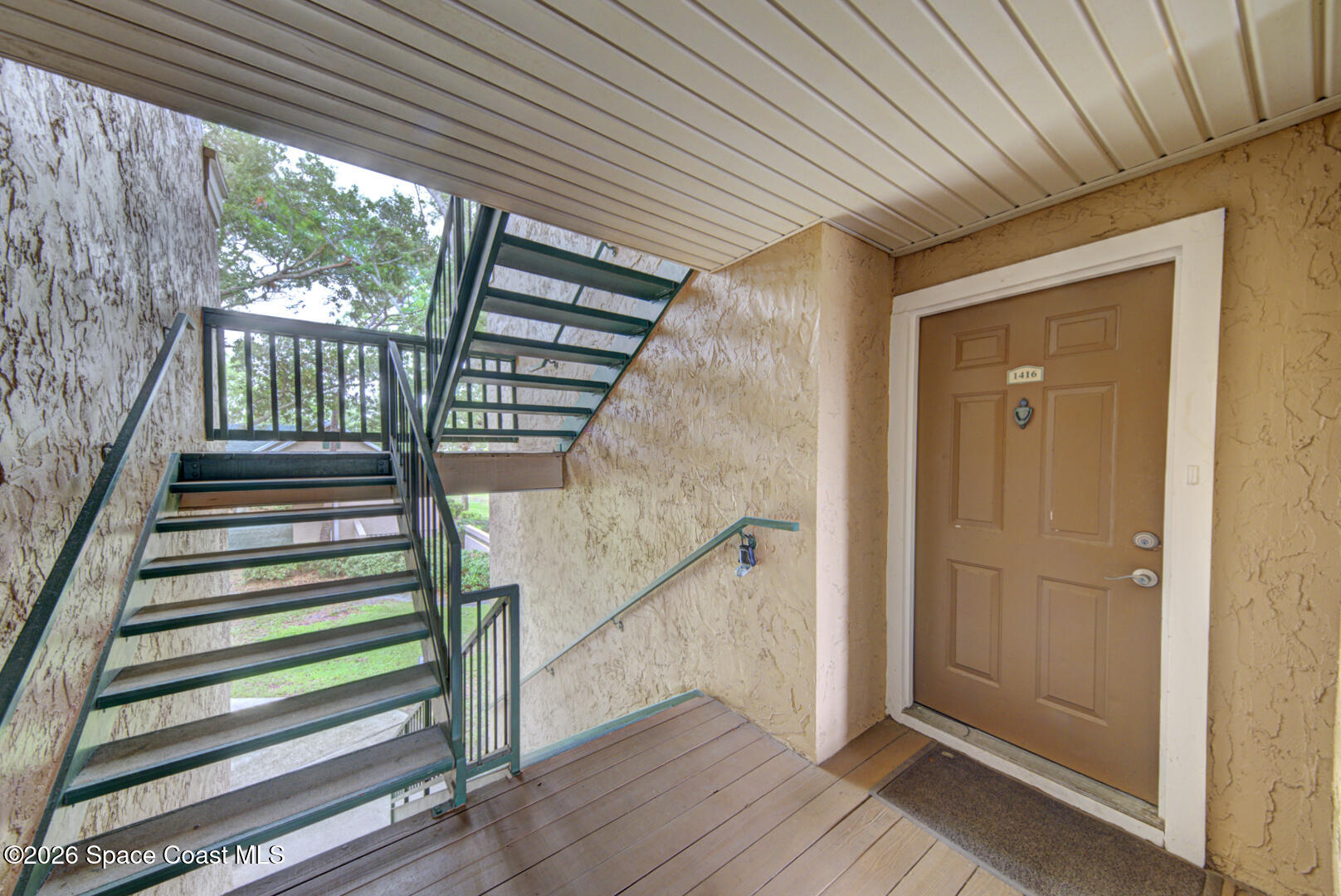 7667 North Wickham Road, Unit 1416 Melbourne, FL 32940 - Photo 2 of 41 front door & stairs to rear of building