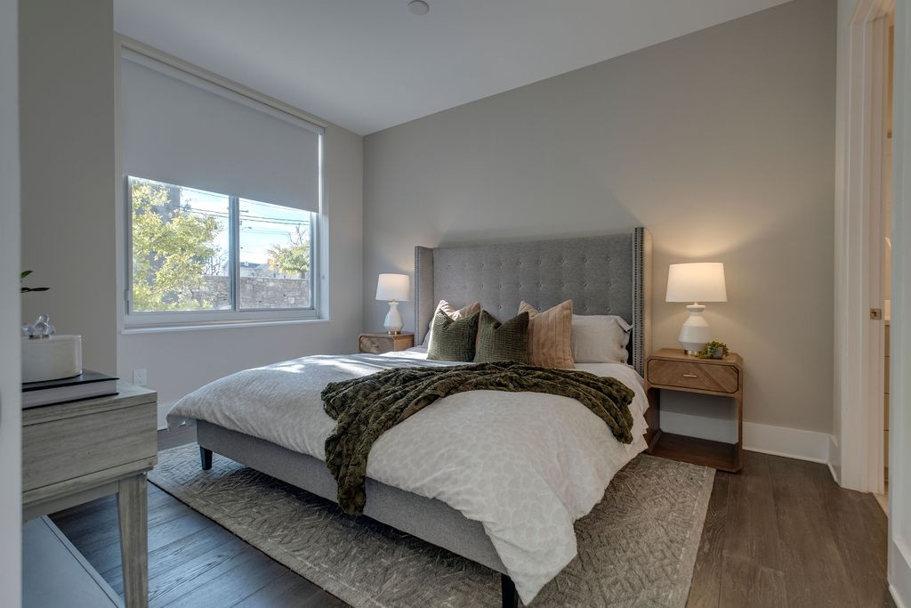 20 Rutledge Street, Unit 111 Nashville, TN 37210 - Photo 11 of 32 a bed sitting in a bedroom next to a window