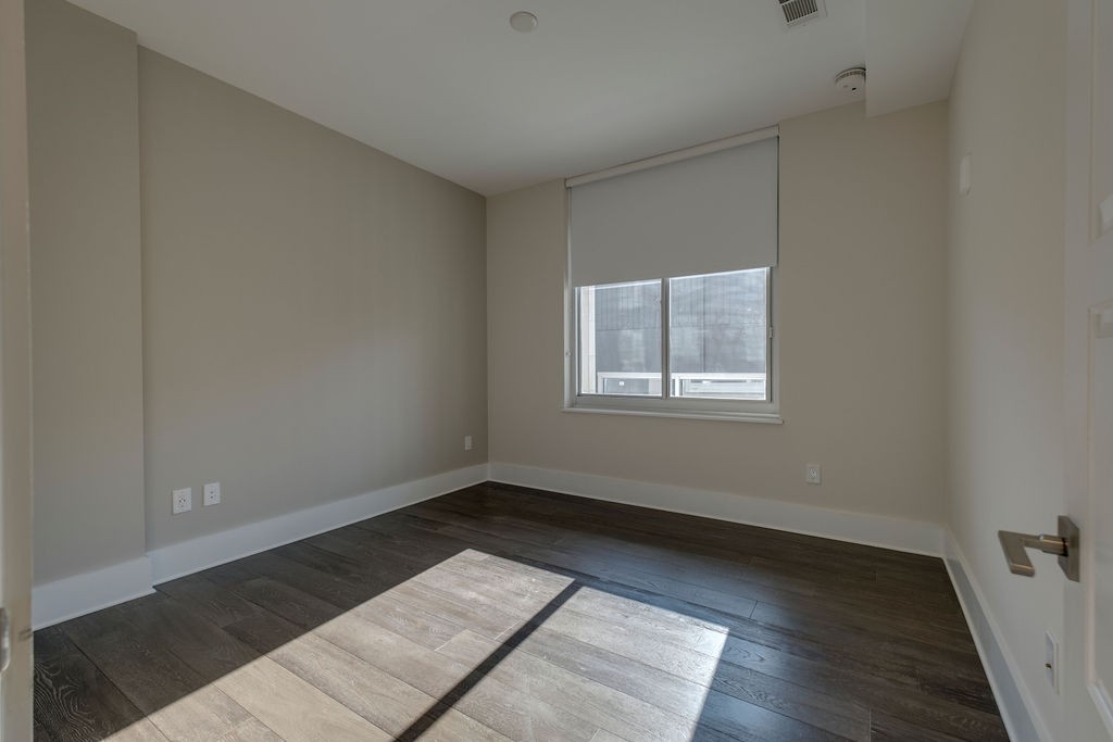 20 Rutledge Street, Unit 111 Nashville, TN 37210 - Photo 15 of 32 a view of an empty room with wooden floor and a window