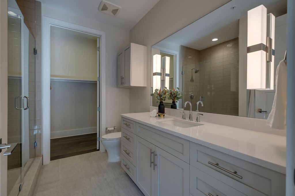 20 Rutledge Street, Unit 111 Nashville, TN 37210 - Photo 16 of 32 a spacious bathroom with a double vanity sink toilet and shower