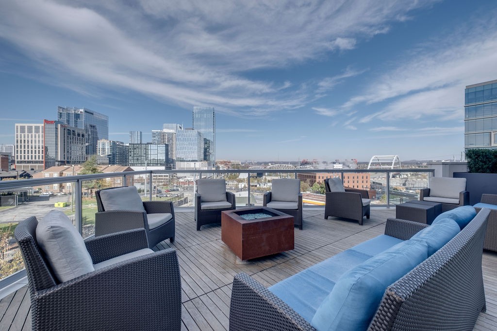 20 Rutledge Street, Unit 111 Nashville, TN 37210 - Photo 25 of 32 a living room with furniture and a view of kitchen