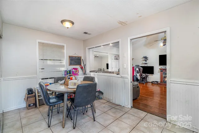 a dining room with furniture and wooden floor