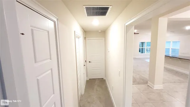 a view of a hallway with wooden shelves