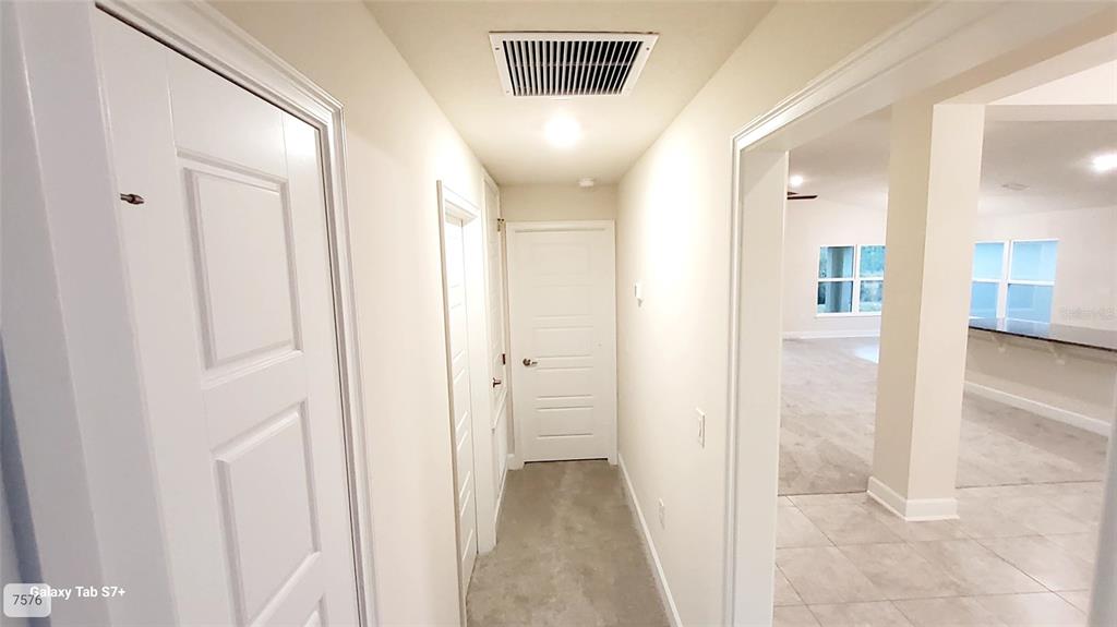 7560 Bent Tree Loop St. Cloud, FL 34773 - Photo 18 of 25 a view of a hallway with wooden shelves