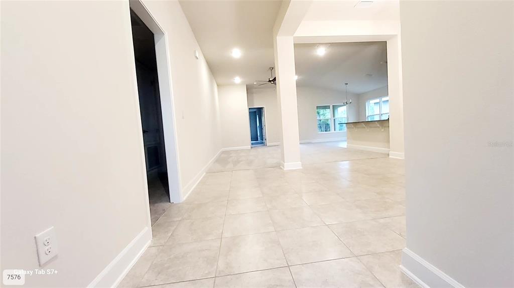 7560 Bent Tree Loop St. Cloud, FL 34773 - Photo 2 of 25 a view of a hallway with wooden floor