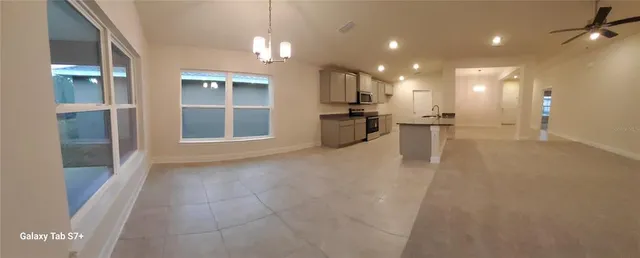 a view of a kitchen with a sink and a refrigerator