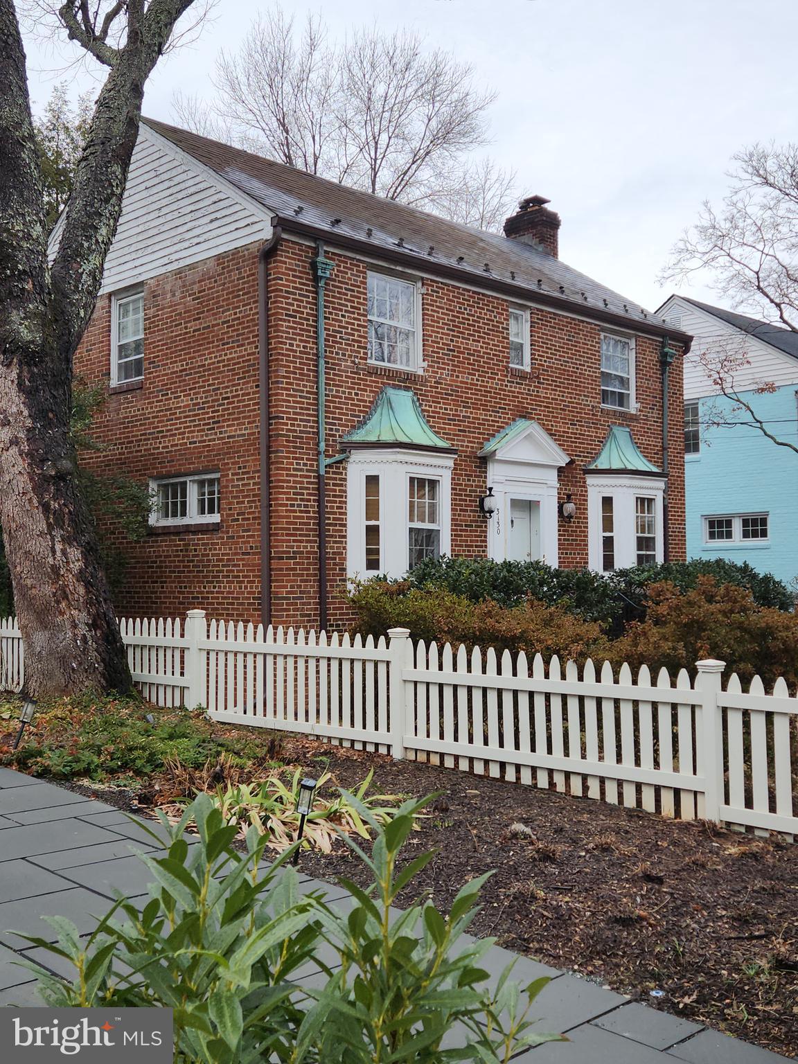 3130 38th Street Northwest Washington, DC 20016 - Photo 2 of 25 a front view of a house with a garden