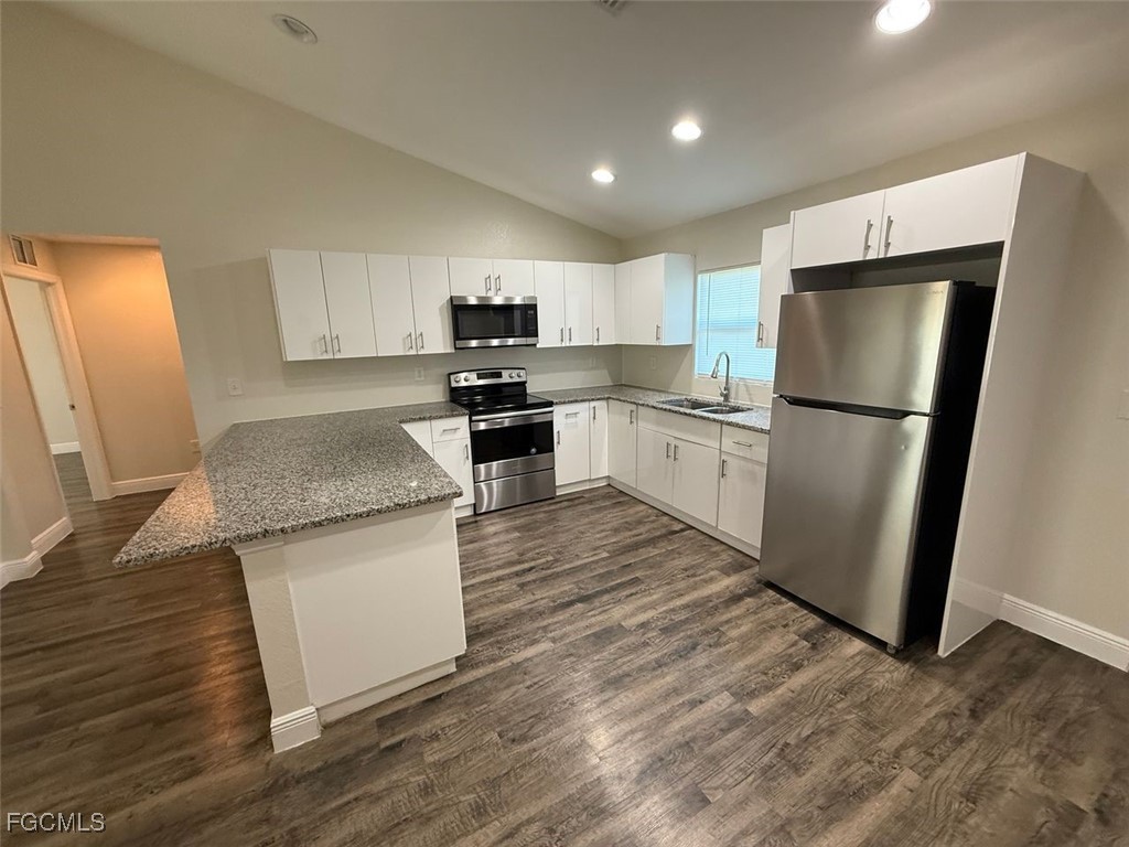 3003 Harvard Circle LaBelle, FL 33935 - Photo 11 of 11 a kitchen with a refrigerator a stove top oven a sink and dishwasher