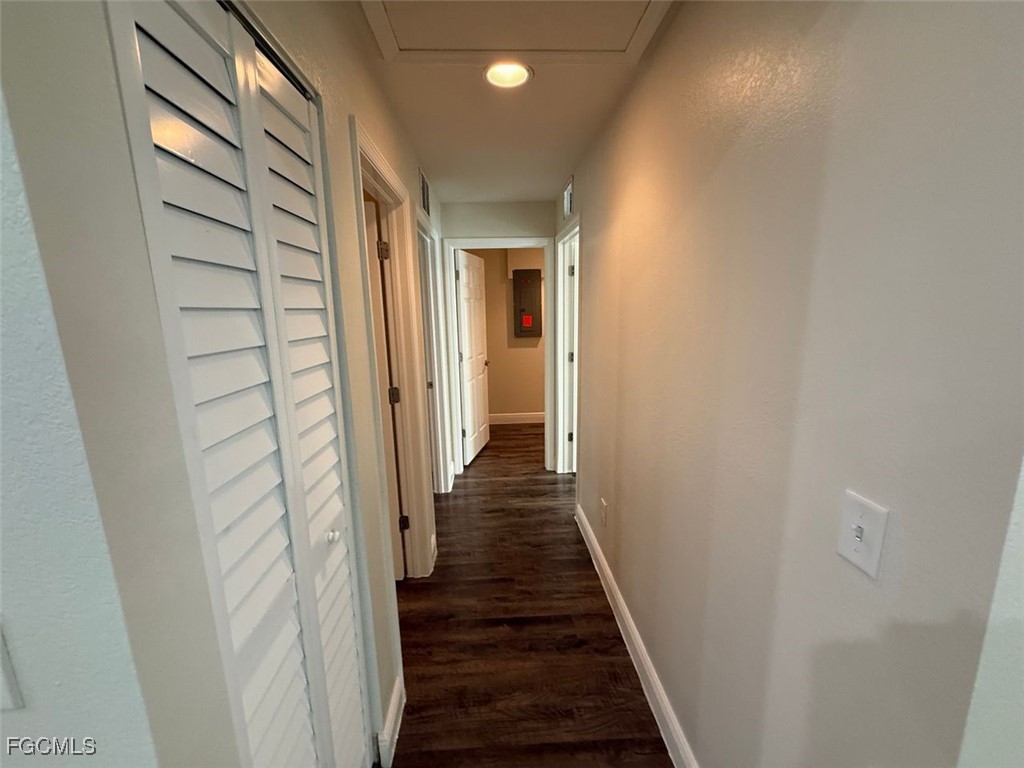 3003 Harvard Circle LaBelle, FL 33935 - Photo 3 of 11 a view of a hallway with a wooden door