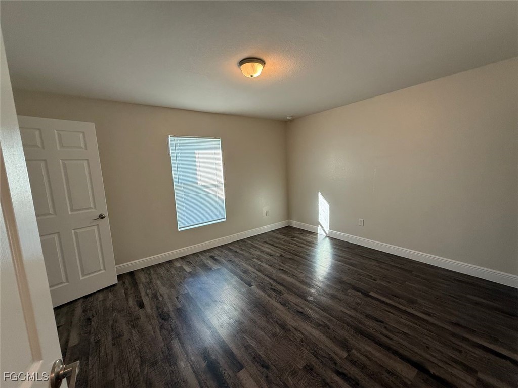 3003 Harvard Circle LaBelle, FL 33935 - Photo 5 of 11 a view of wooden floor and windows in a room