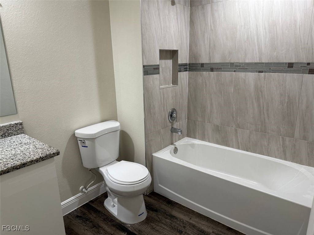 3003 Harvard Circle LaBelle, FL 33935 - Photo 7 of 11 a bathroom with a toilet and a bathtub