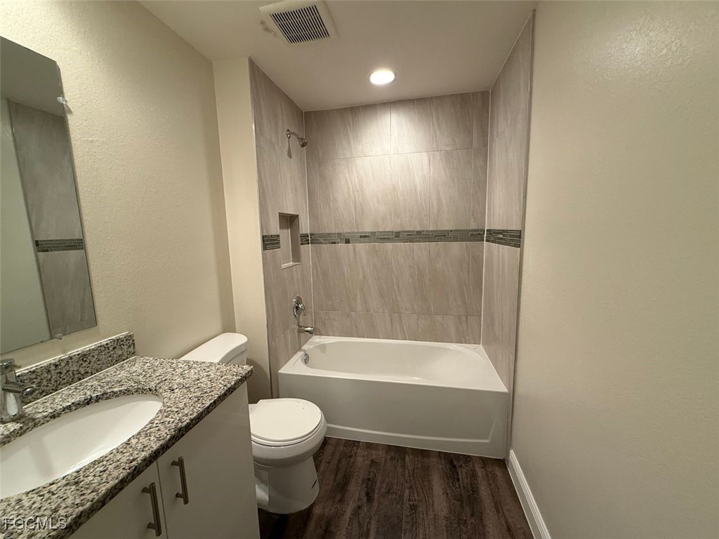 3003 Harvard Circle LaBelle, FL 33935 - Photo 9 of 11 a bathroom with a granite countertop sink toilet and shower