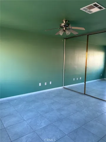 a view of a livingroom with a chandelier fan and a fan