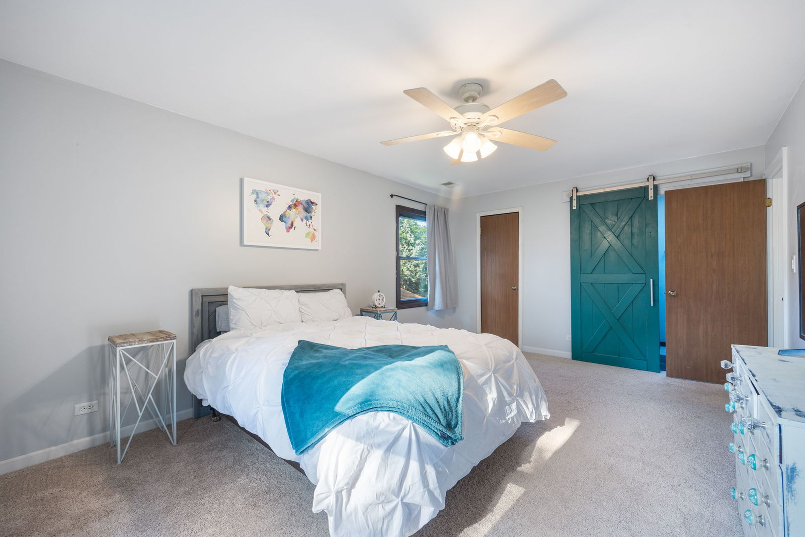 1932 Gresham Circle, Unit C Wheaton, IL 60189 - Photo 16 of 27 a bedroom with a large bed and a chandelier