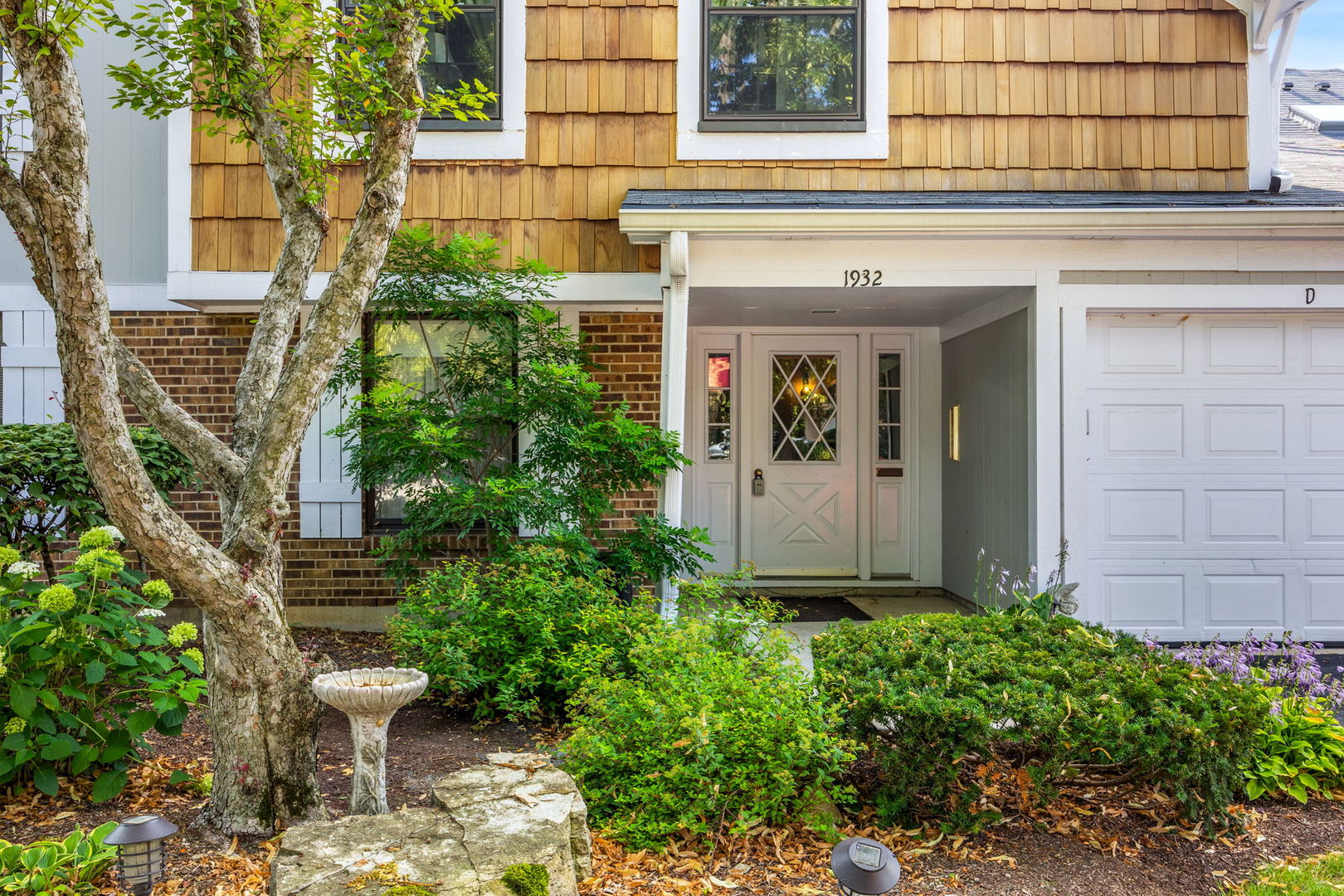 1932 Gresham Circle, Unit C Wheaton, IL 60189 - Photo 2 of 27 a view of a house with a small garden
