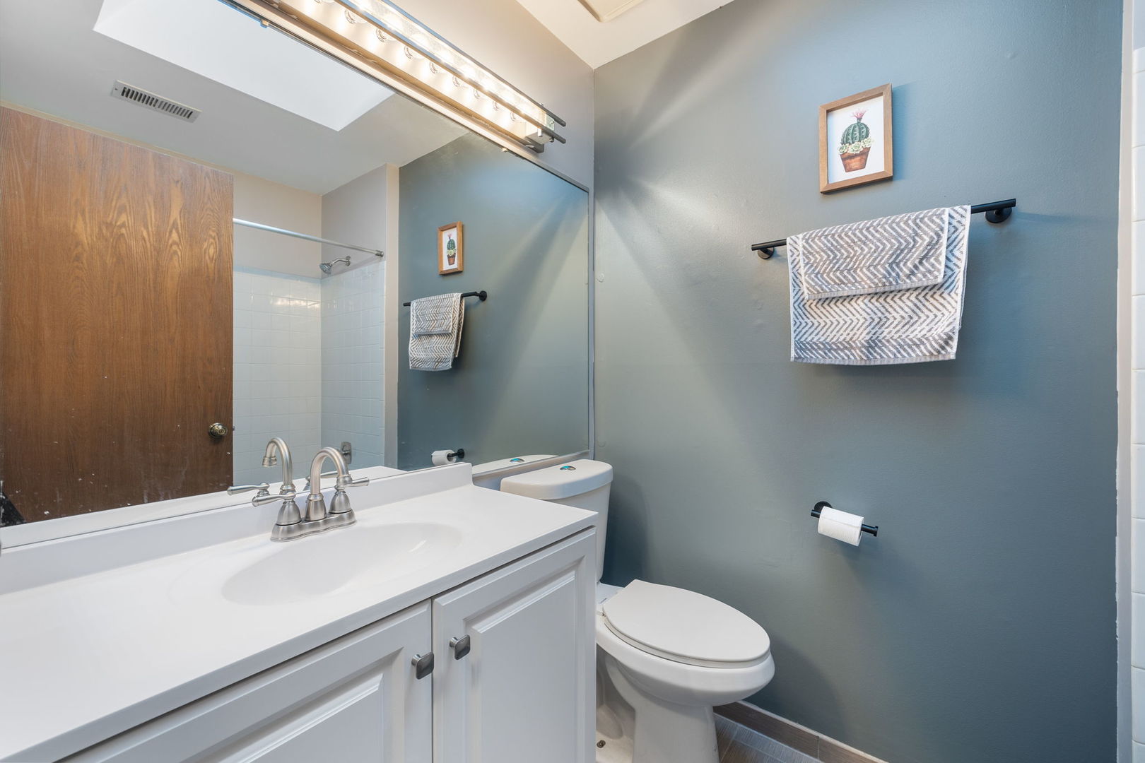 1932 Gresham Circle, Unit C Wheaton, IL 60189 - Photo 21 of 27 a bathroom with a sink mirror and toilet