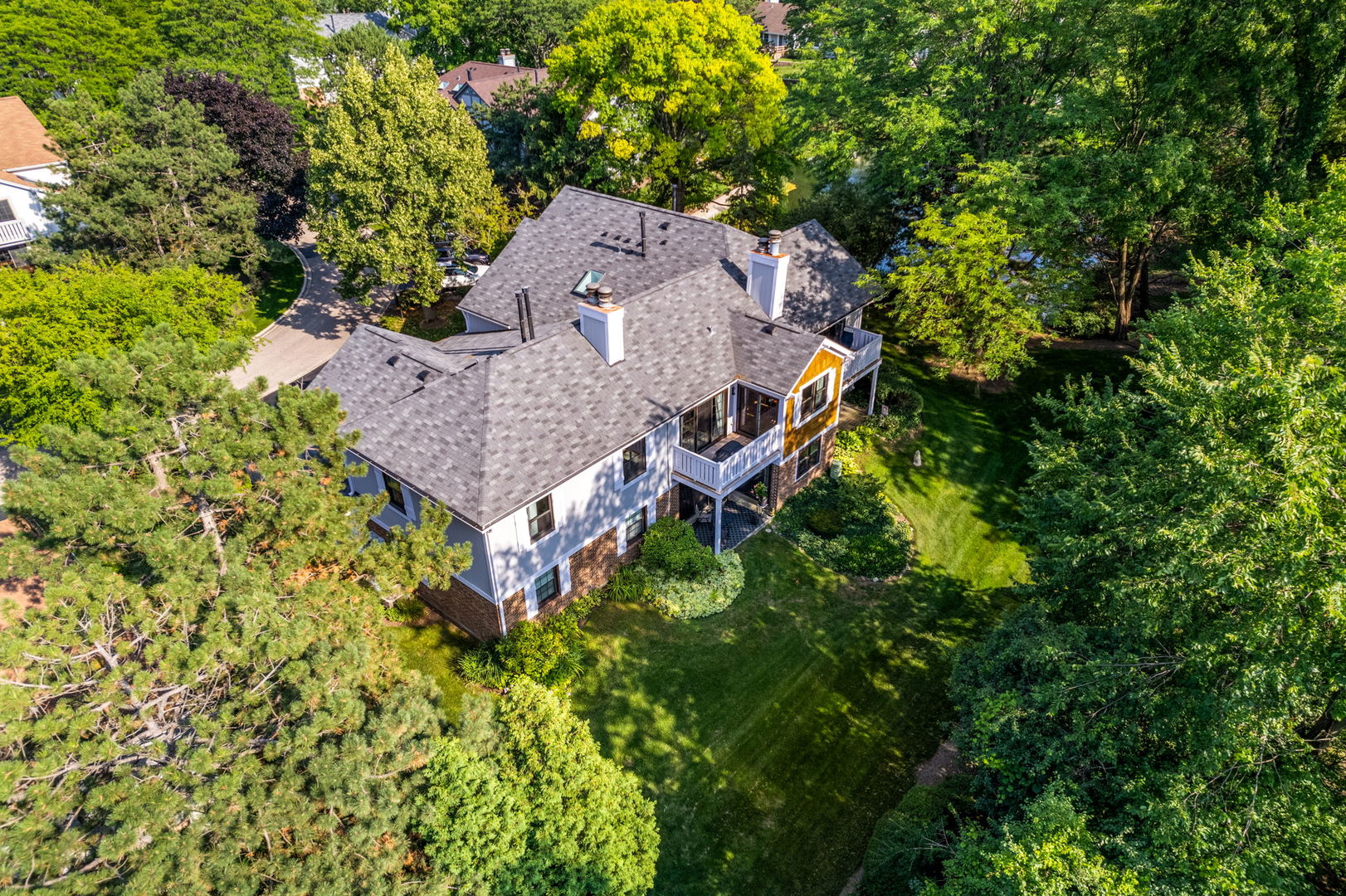 1932 Gresham Circle, Unit C Wheaton, IL 60189 - Photo 25 of 27 an aerial view of a house with large trees and plants