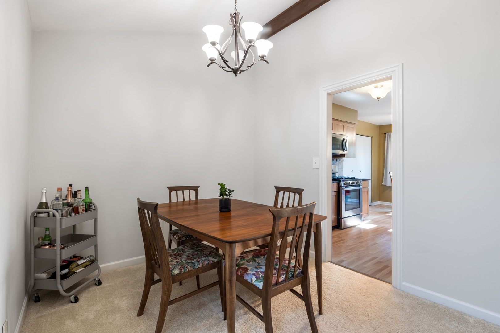 1932 Gresham Circle, Unit C Wheaton, IL 60189 - Photo 9 of 27 a view of a dining room with furniture and chandelier