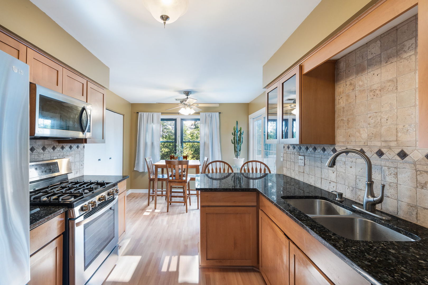 1932 Gresham Circle, Unit C Wheaton, IL 60189 - Photo 10 of 27 a kitchen with sink a stove and cabinets