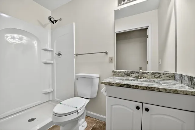 a bathroom with a shower and a toilet