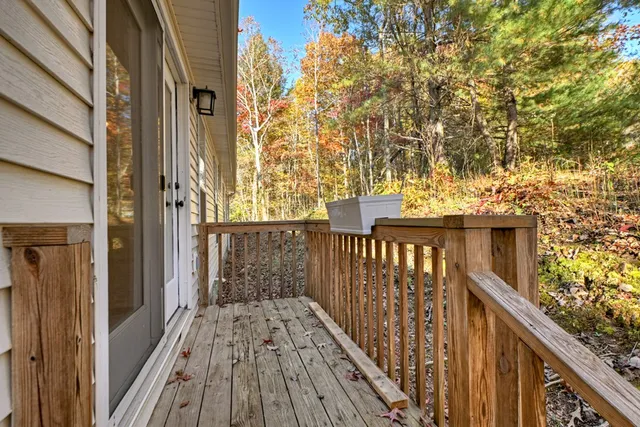 a view of a wooden balcony and trees