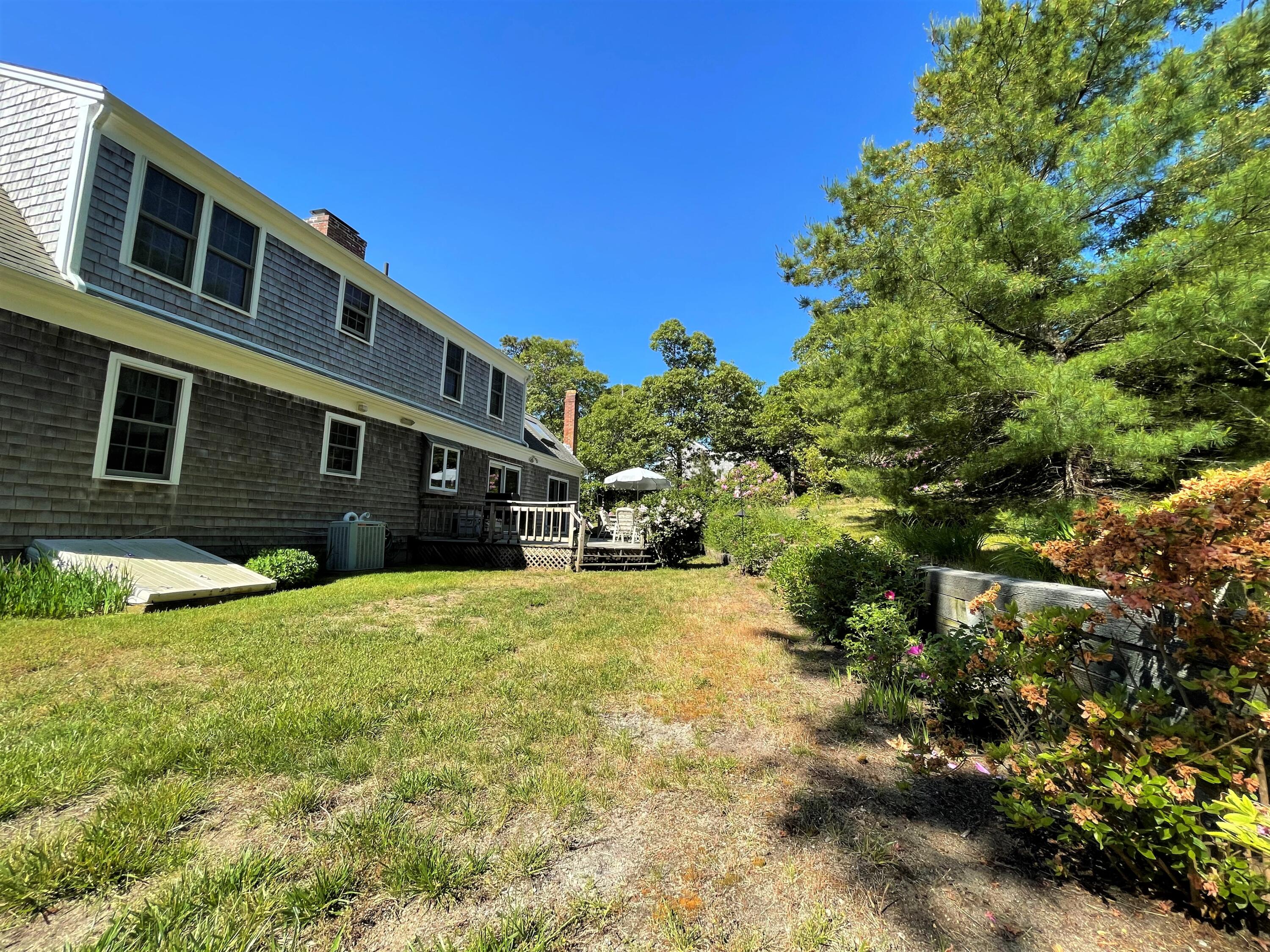 144 Long Road Harwich, MA 02645 - Photo 12 of 49 a front view of a house with a yard