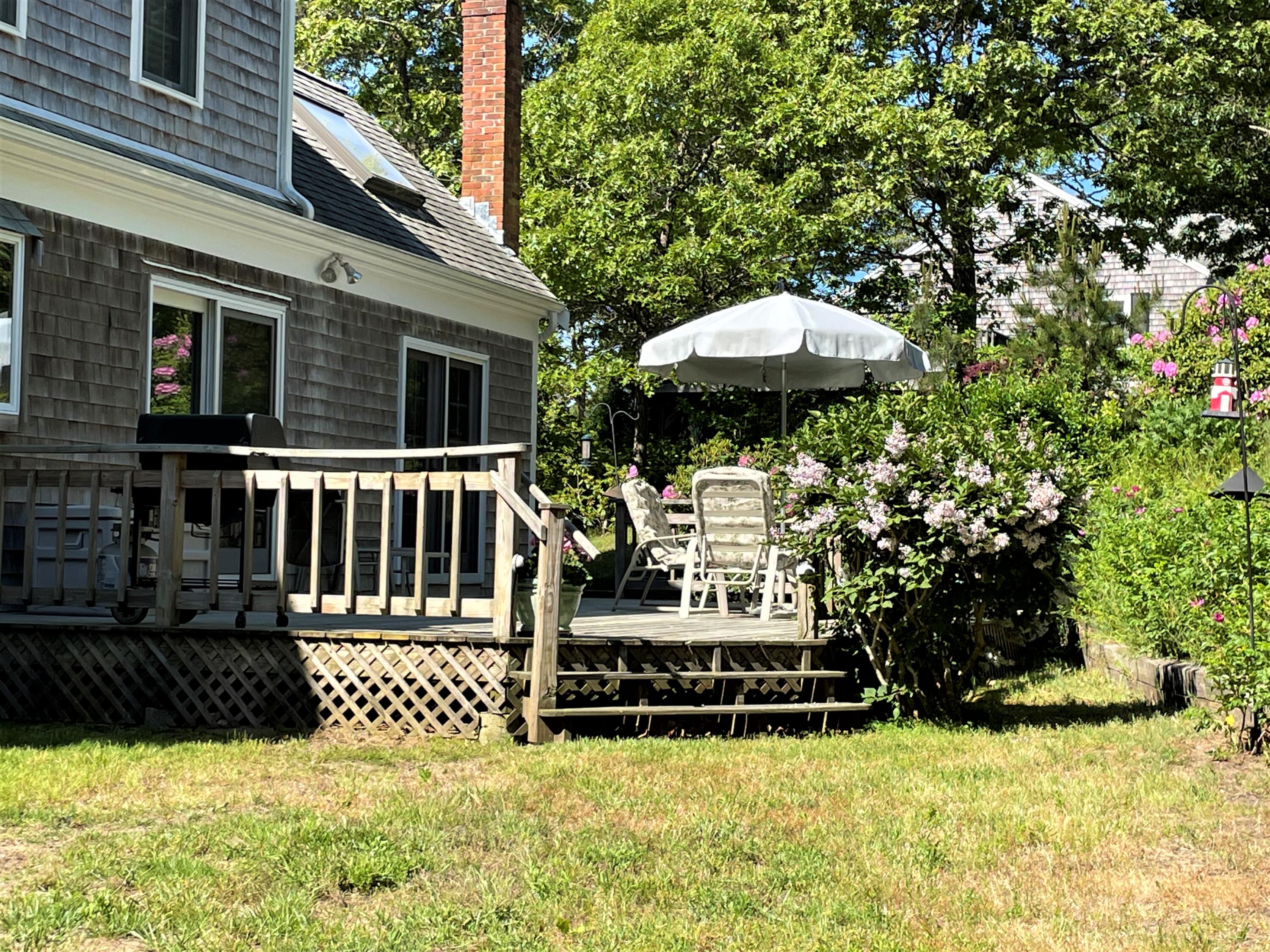 144 Long Road Harwich, MA 02645 - Photo 13 of 49 a view of a house with backyard and sitting area