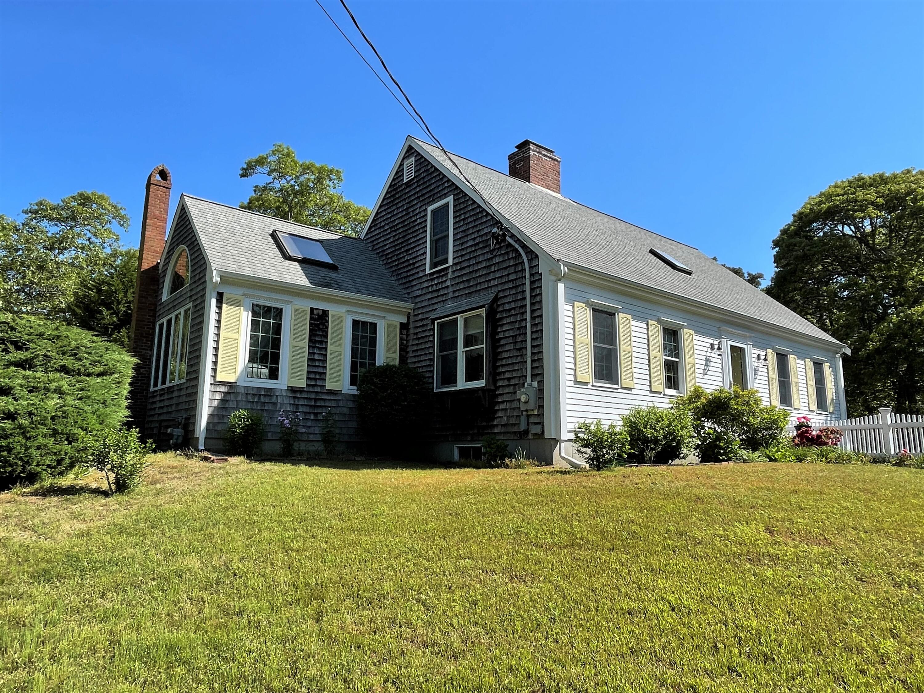 144 Long Road Harwich, MA 02645 - Photo 14 of 49 a front view of a house with a yard