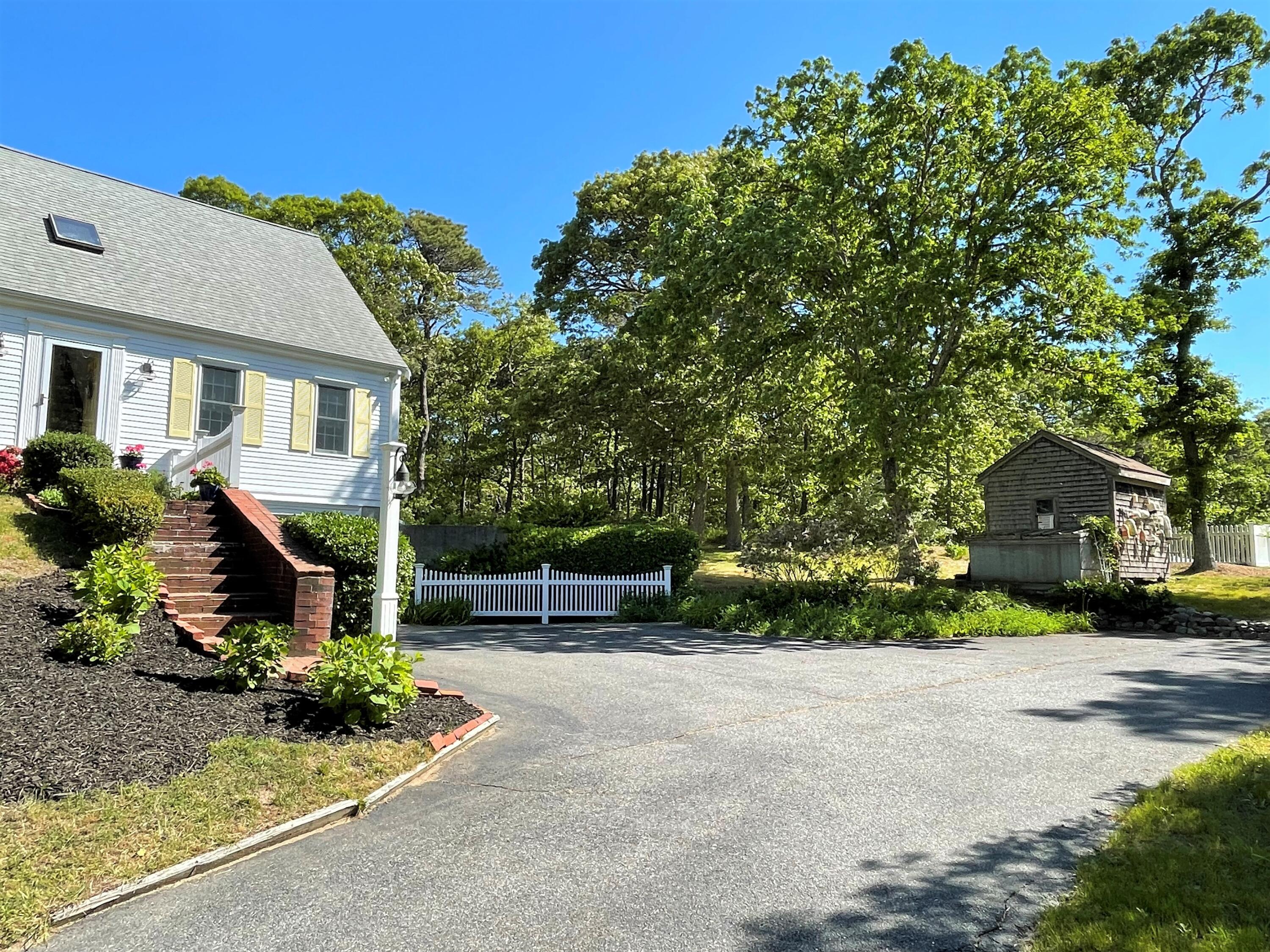 144 Long Road Harwich, MA 02645 - Photo 16 of 49 a front view of a house with garden