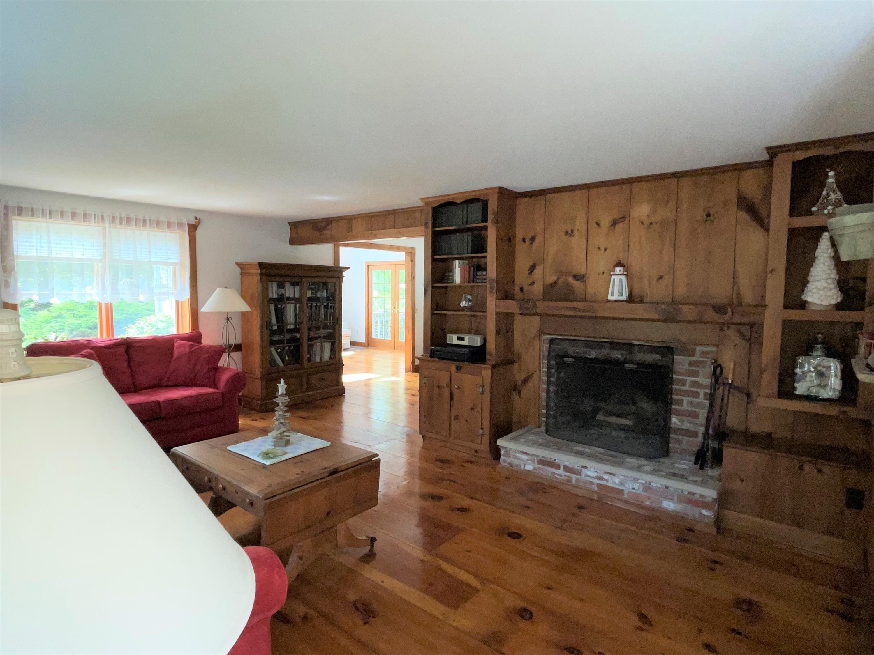 144 Long Road Harwich, MA 02645 - Photo 18 of 49 a living room with furniture a fireplace and a flat screen tv