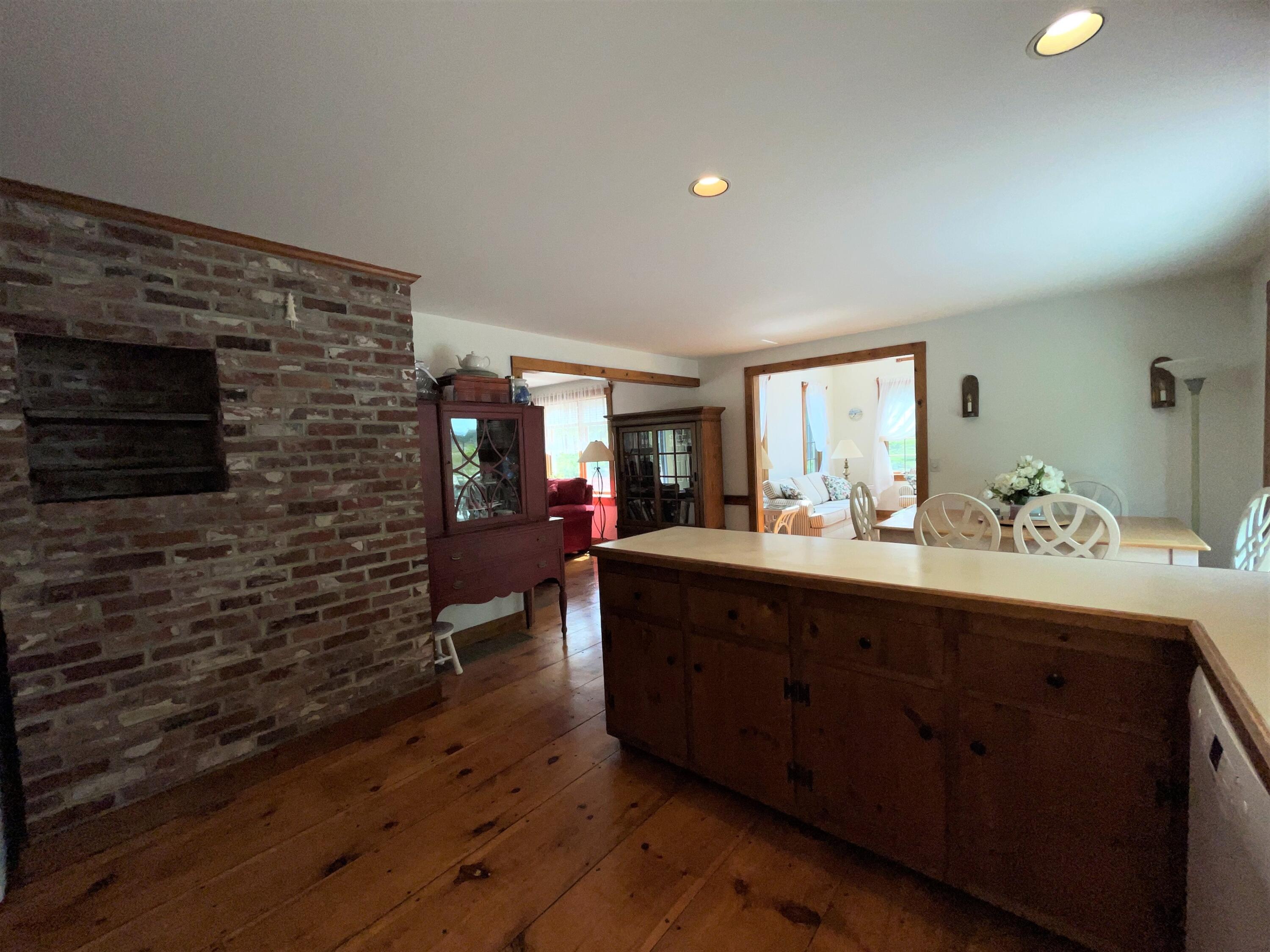 144 Long Road Harwich, MA 02645 - Photo 22 of 49 a living room with fireplace furniture and a flat screen tv